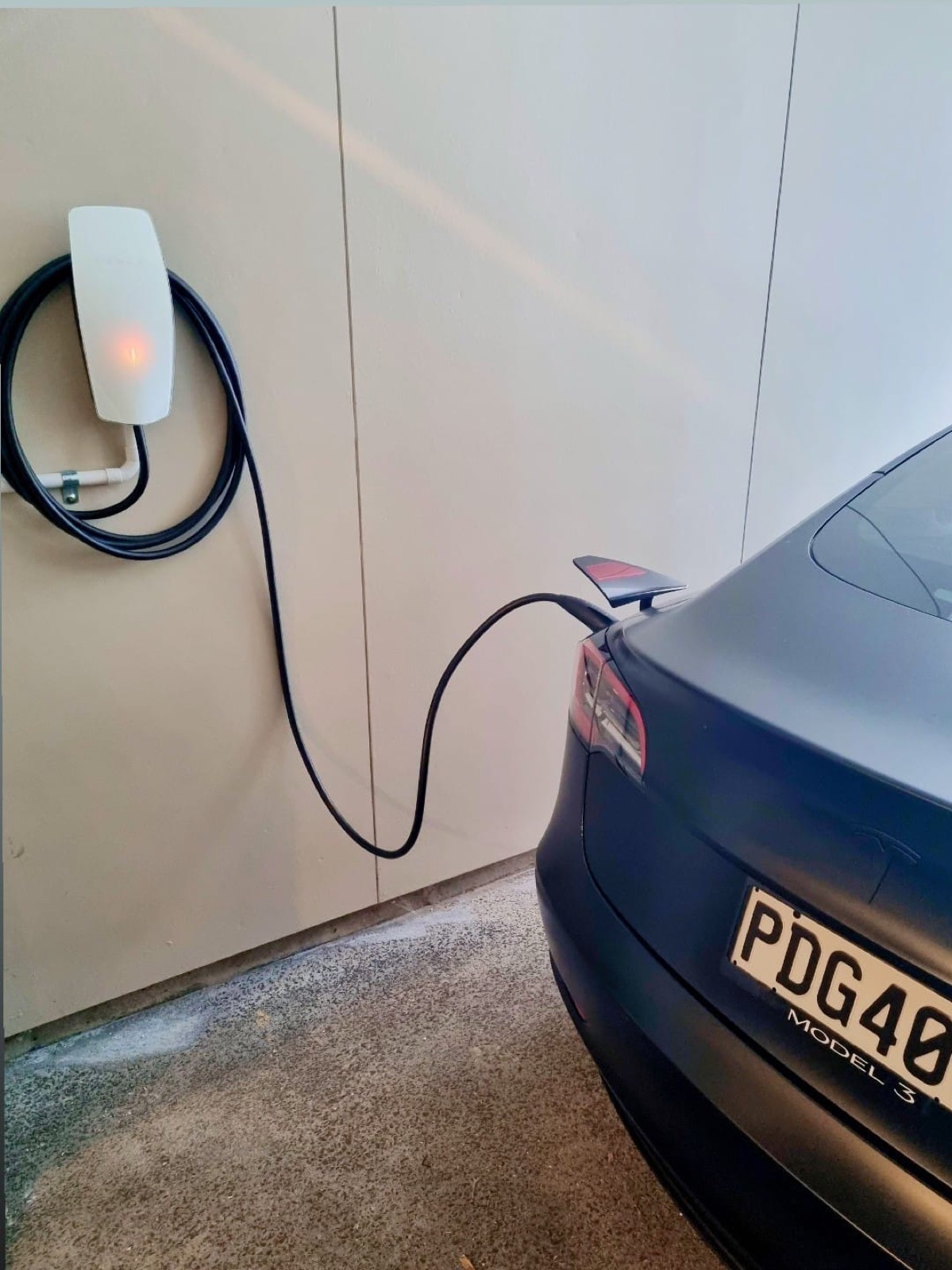 An EV charger installed on a garage wall